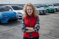 “Fleet Optimization – A fleet manager standing confidently in front of modern vehicles, representing efficient fleet management in 2025.”